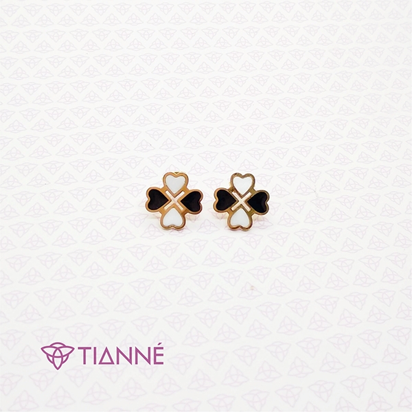 Arete en acero dorado con fondo negro y blanco forma de trebol de corazones